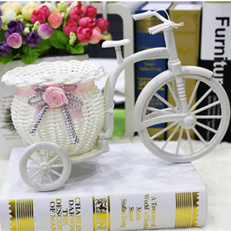 Rattan bicycle-shaped flower holder with a woven container – shown in a room setting