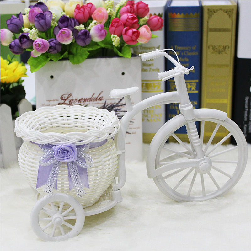 Rattan bicycle-shaped flower holder with a woven container – shown in a room setting (2)