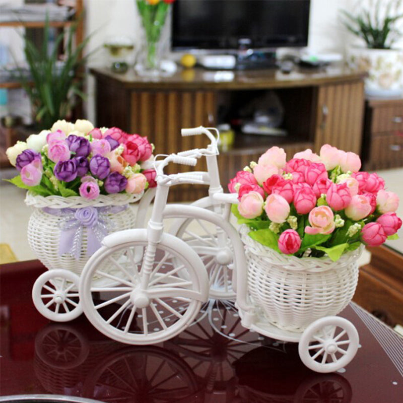 Rattan bicycle-shaped flower holder with a woven container – shown in a room setting (3)