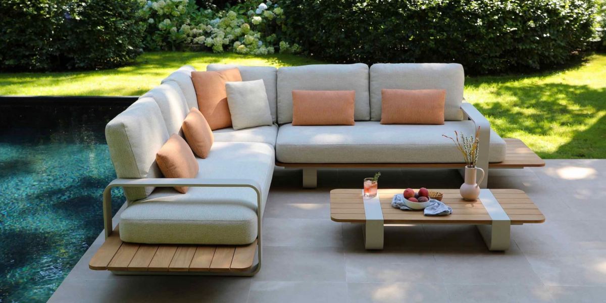 Outdoor sectional with a teak base on a garden terrace