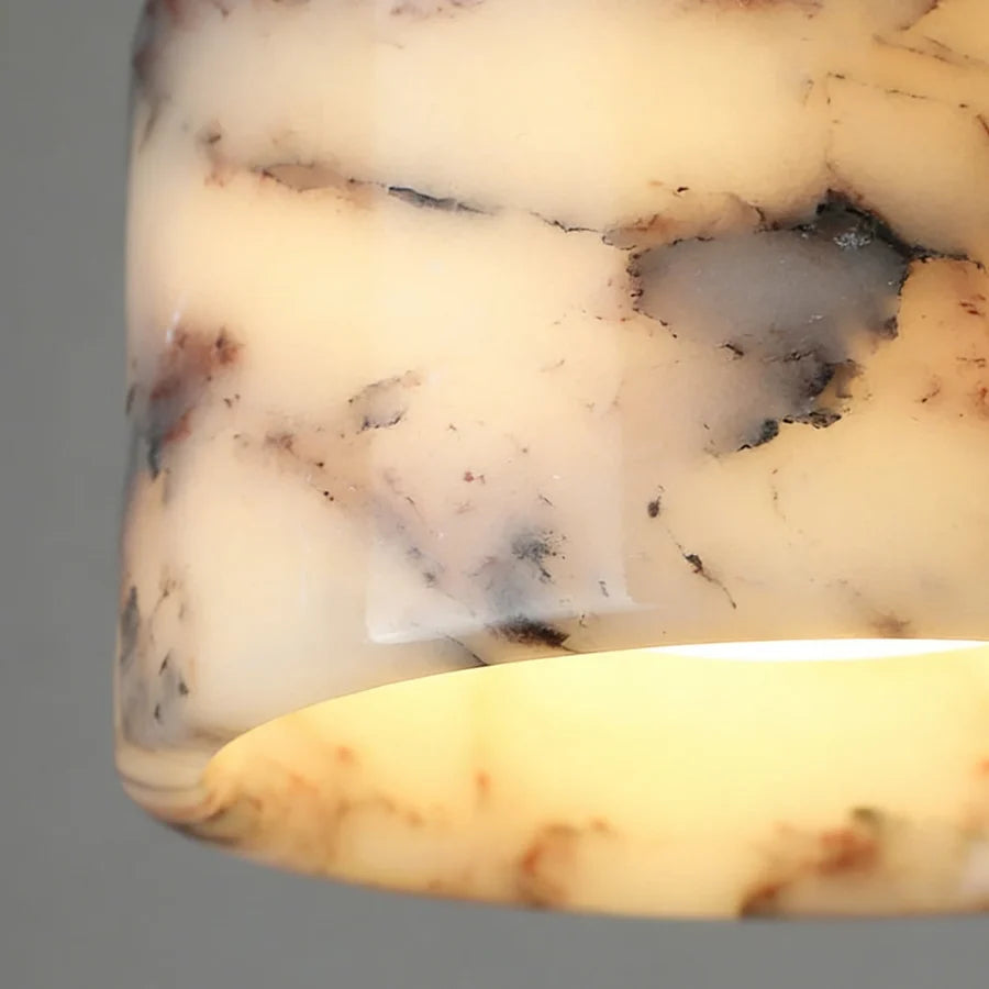 Close-up of a marble pendant light with warm veining