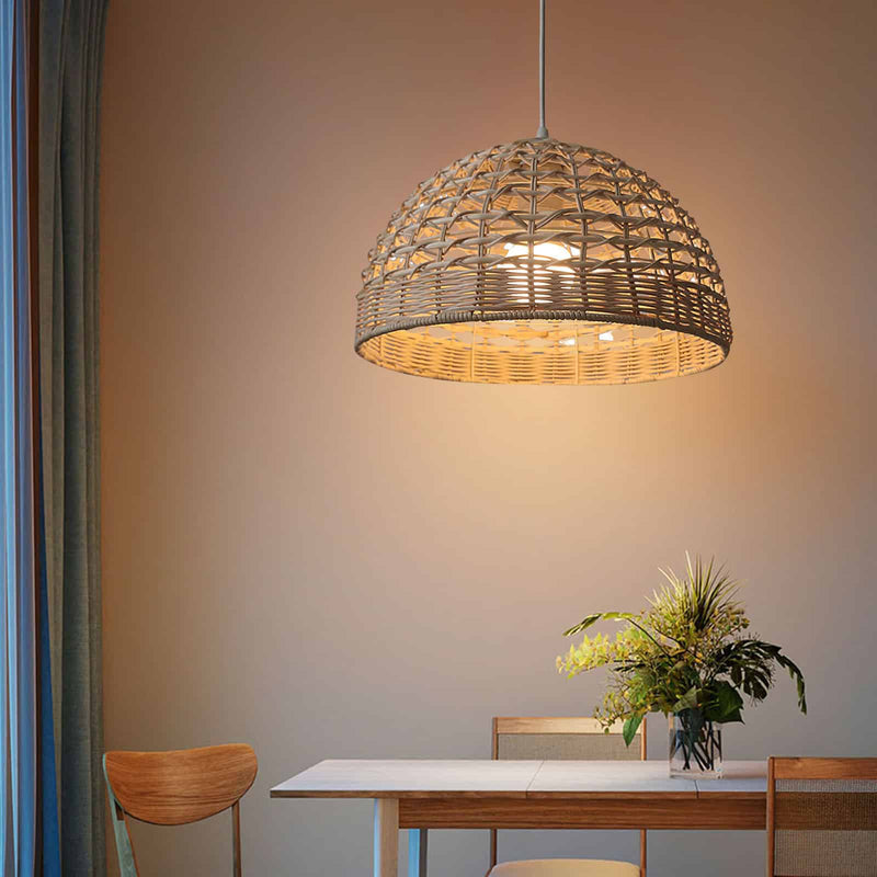 Ovoid handwoven rattan and wicker pendant shade – shown lit in a room setting