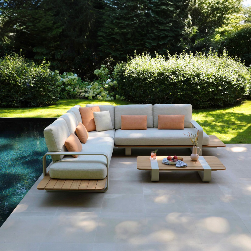 Romeo beige aluminum outdoor sectional with sculpted teak armrests – shown outdoors
