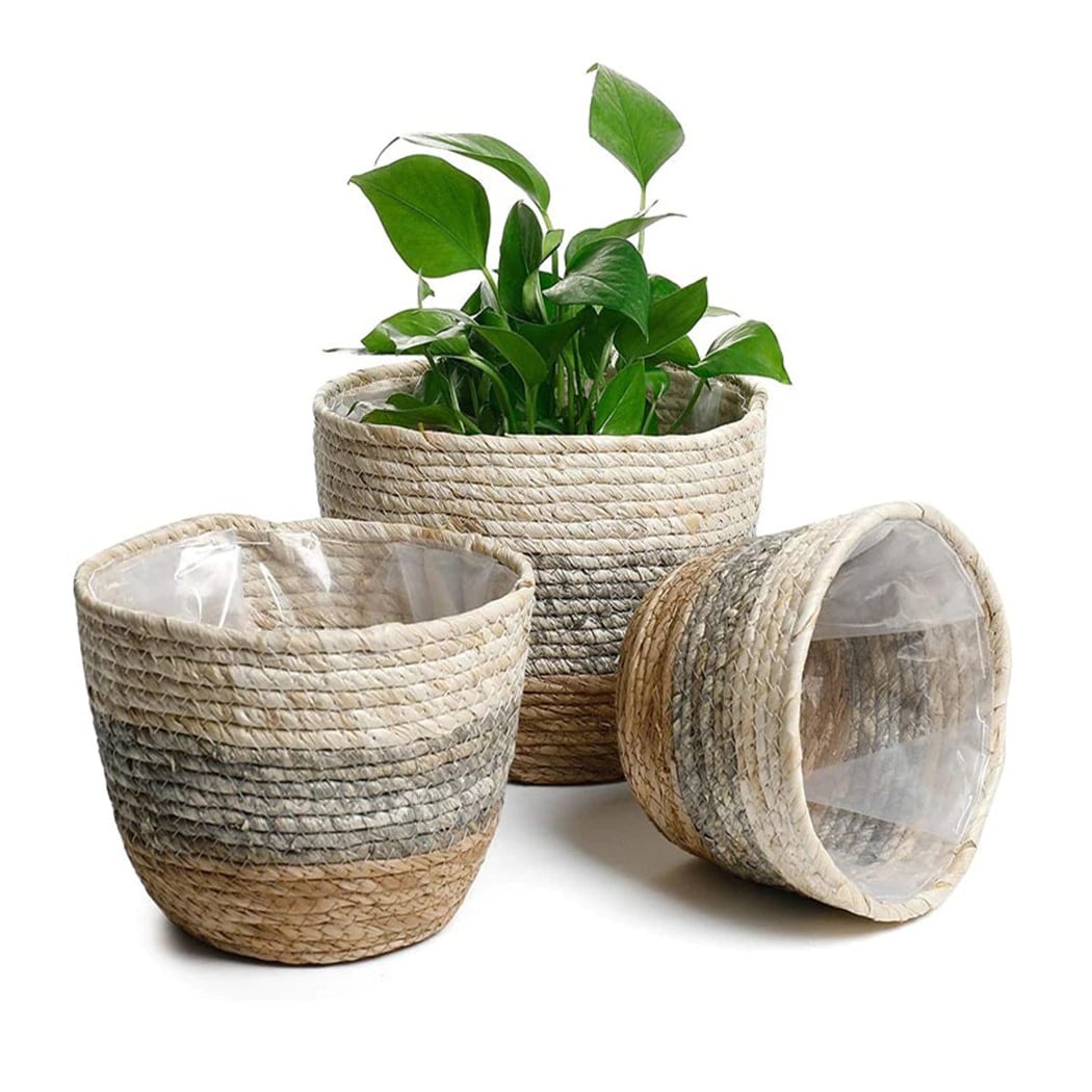 Woven rattan storage basket with integrated handles – shown in a room setting