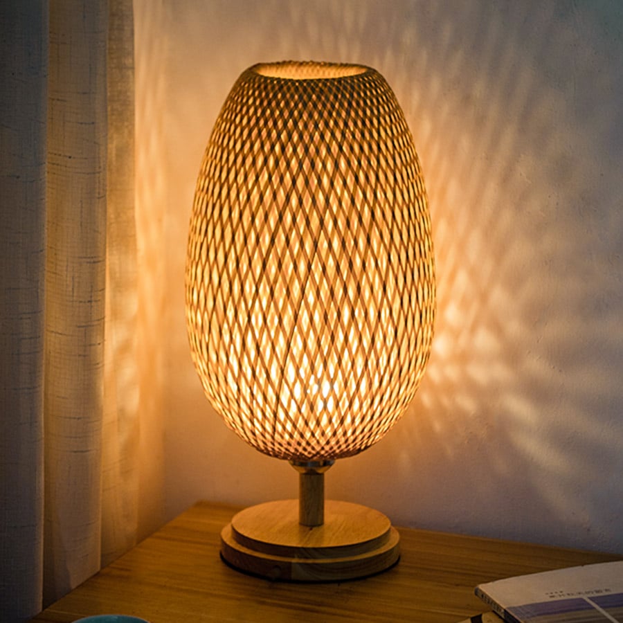Handwoven natural rattan table lamp – shown lit