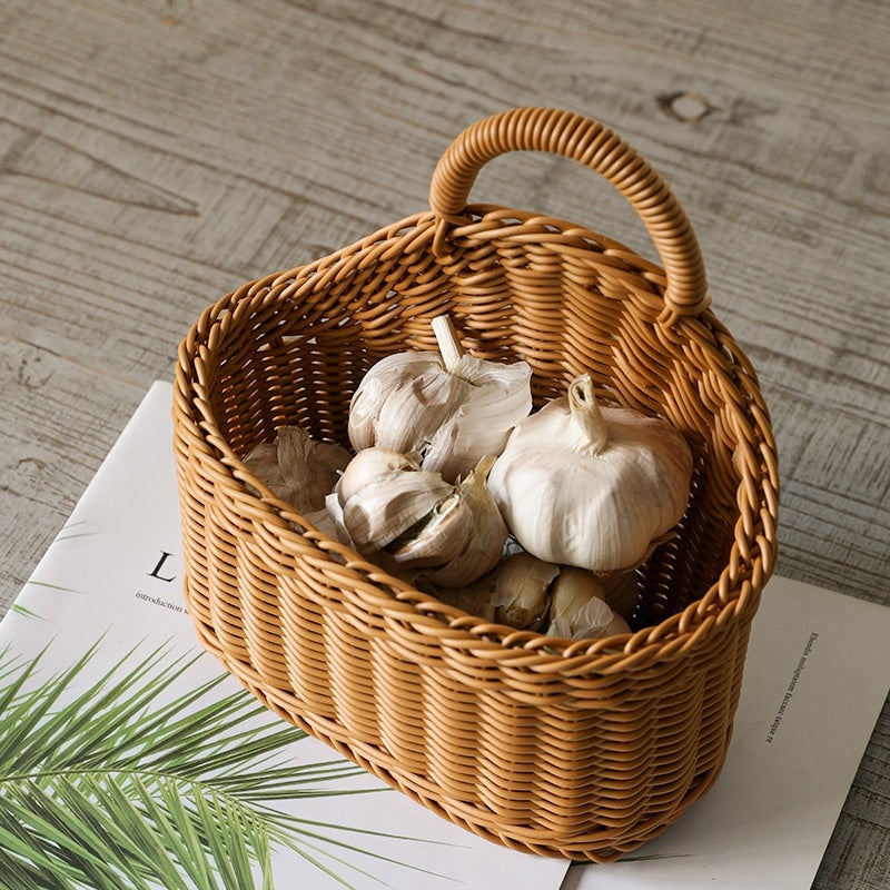 Woven natural rattan storage basket with a sturdy handle – shown in a room setting