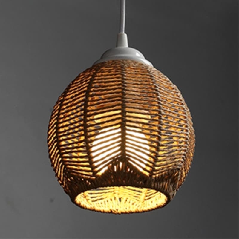 Rustic woven rattan lamp shade with golden reflections – teardrop variant, shown lit