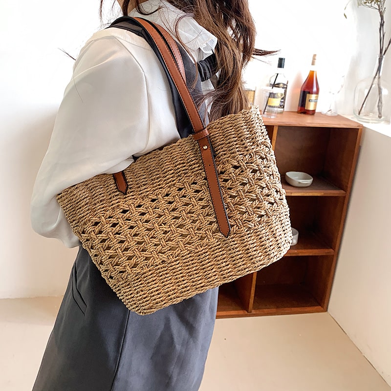 Structured handwoven straw handbag – worn by a model (2)