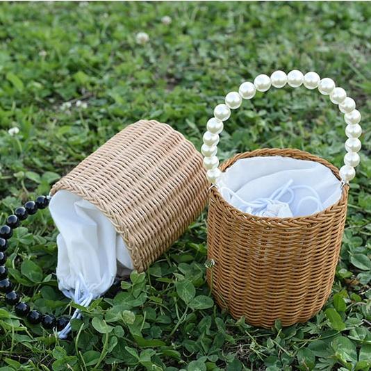 Kids woven storage basket with a beaded handle – shown outdoors (3)