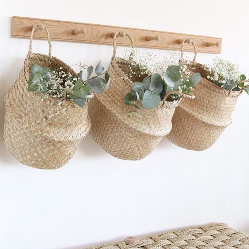 Wicker basket with symmetrical handwoven handles – shown in a room setting