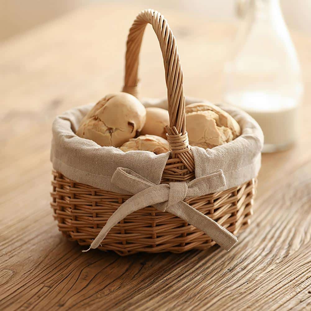 Woven storage basket with a handle and beige fabric lining – shown in a room setting