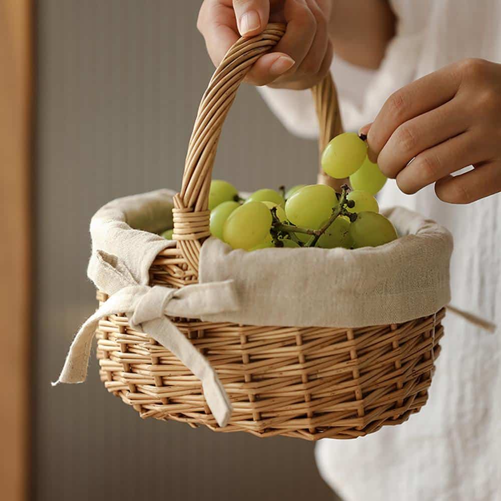 Woven storage basket with a handle and beige fabric lining – shown in use