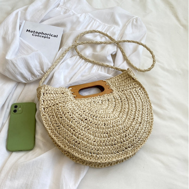 Rounded rattan handbag with a raw wood handle – another view