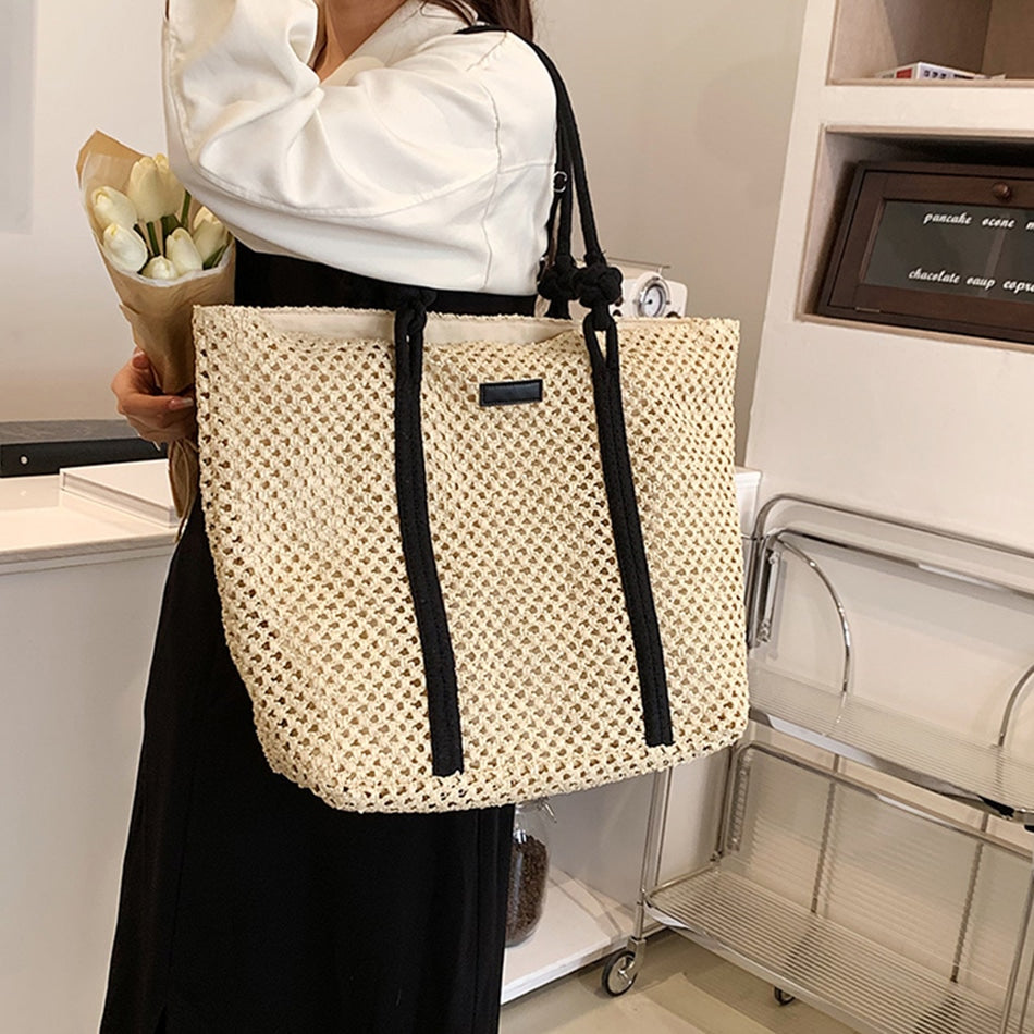 Woven straw handbag with handles – worn by a model (2)