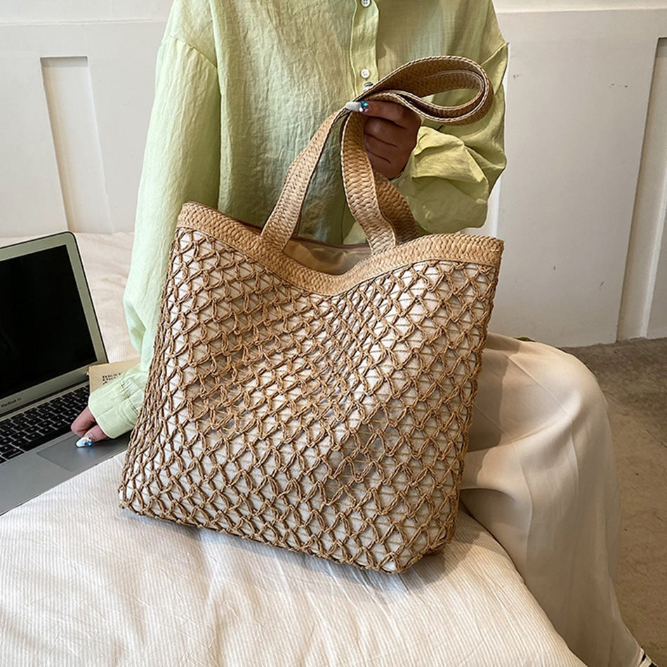 Golden woven handbag with a central zipper – worn by a model
