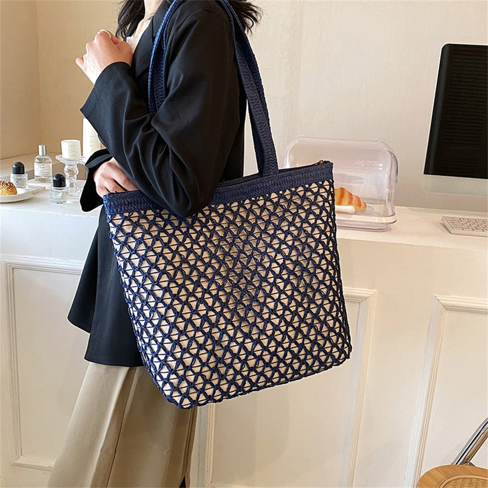 Golden woven handbag with a central zipper – blue version, worn by a model