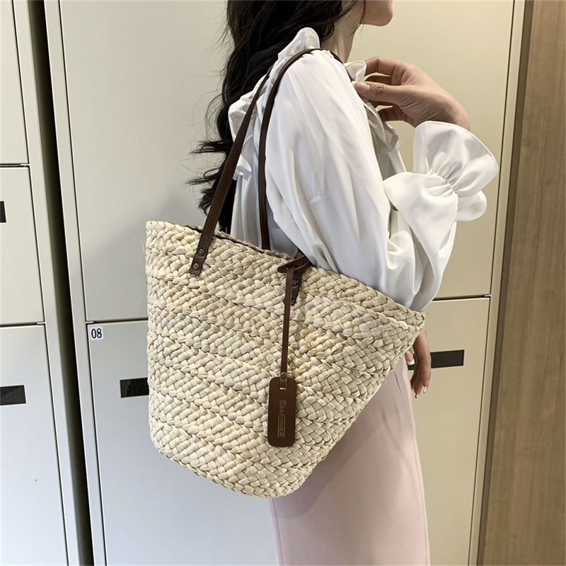 Boho handwoven straw handbag – worn by a model (2)