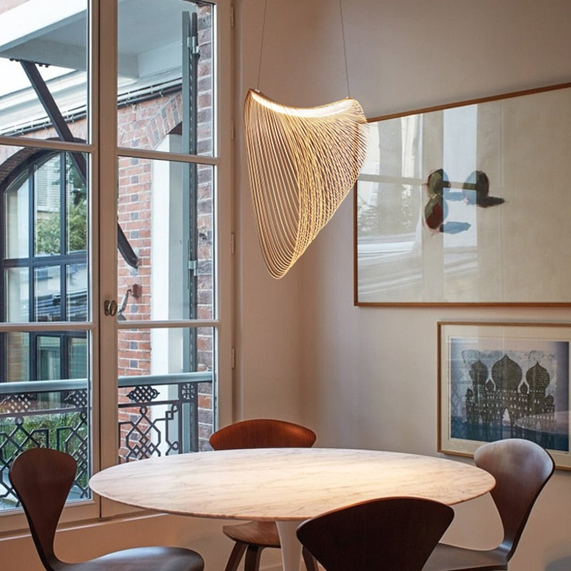 Futuristic geometric wood blade pendant light – shown in a room setting (3)
