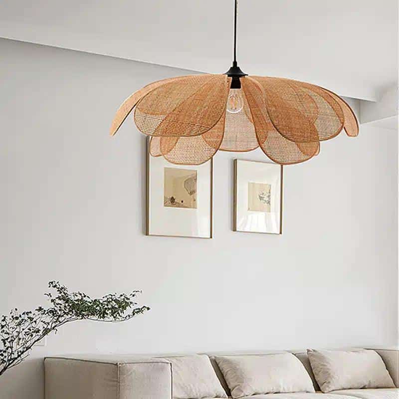 Minimalist handwoven rattan flower pendant light with geometric petals – shown in a room setting