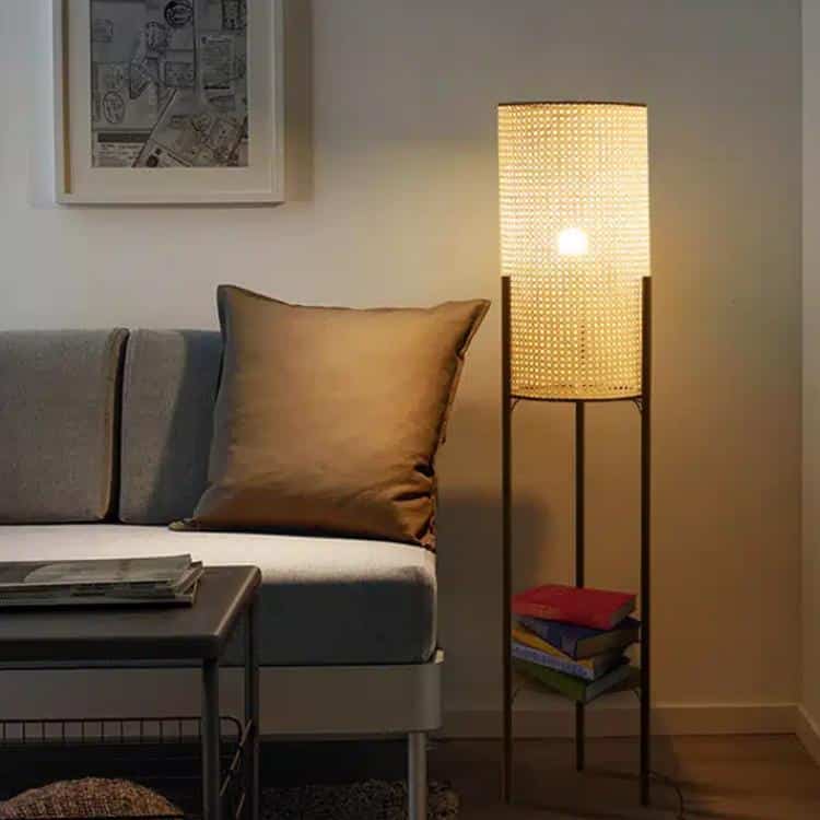 Modern cylindrical rattan table lamp on a matte metal stand – shown lit in a room setting (2)