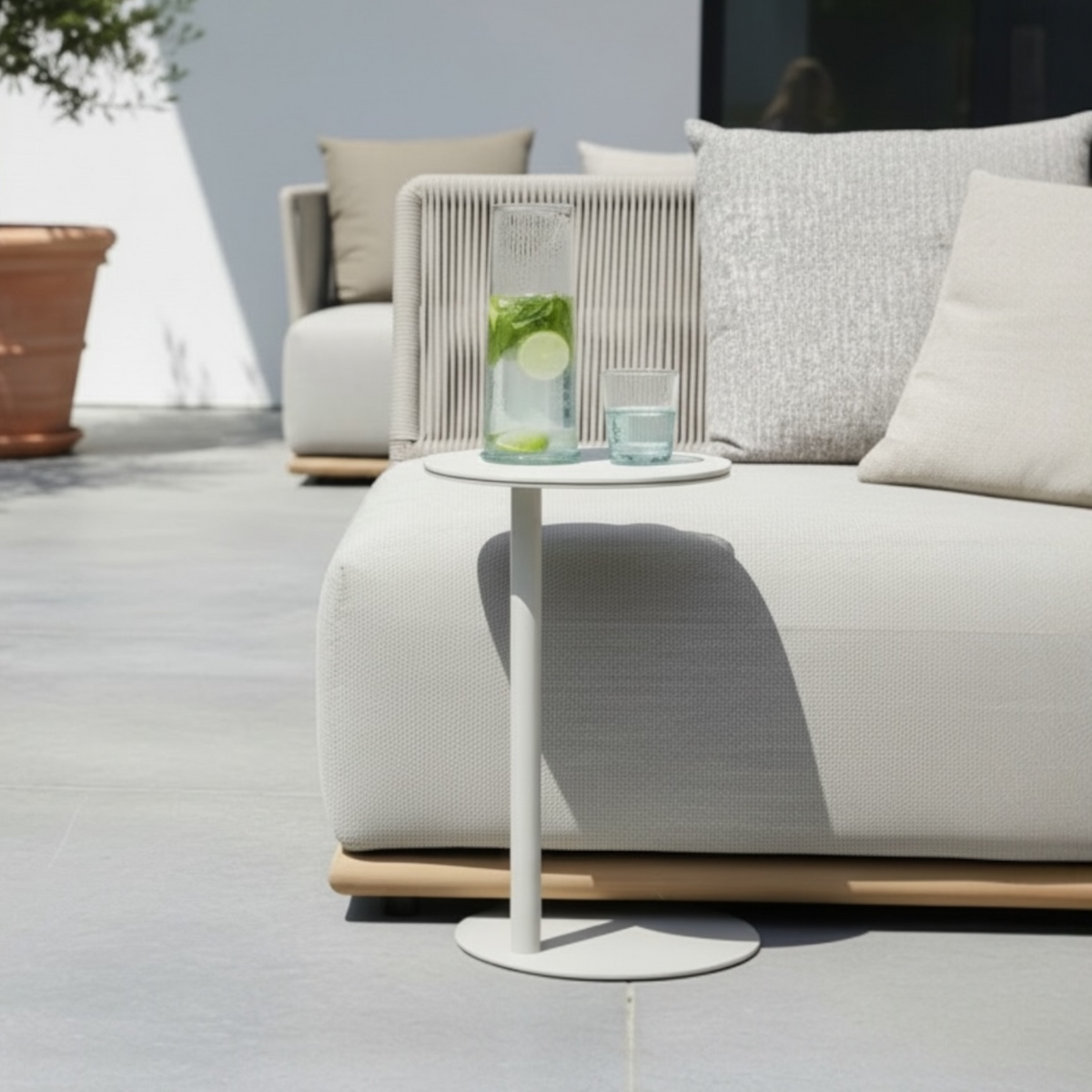 Bulter beige aluminum round ceramic side table – shown outdoors (2)