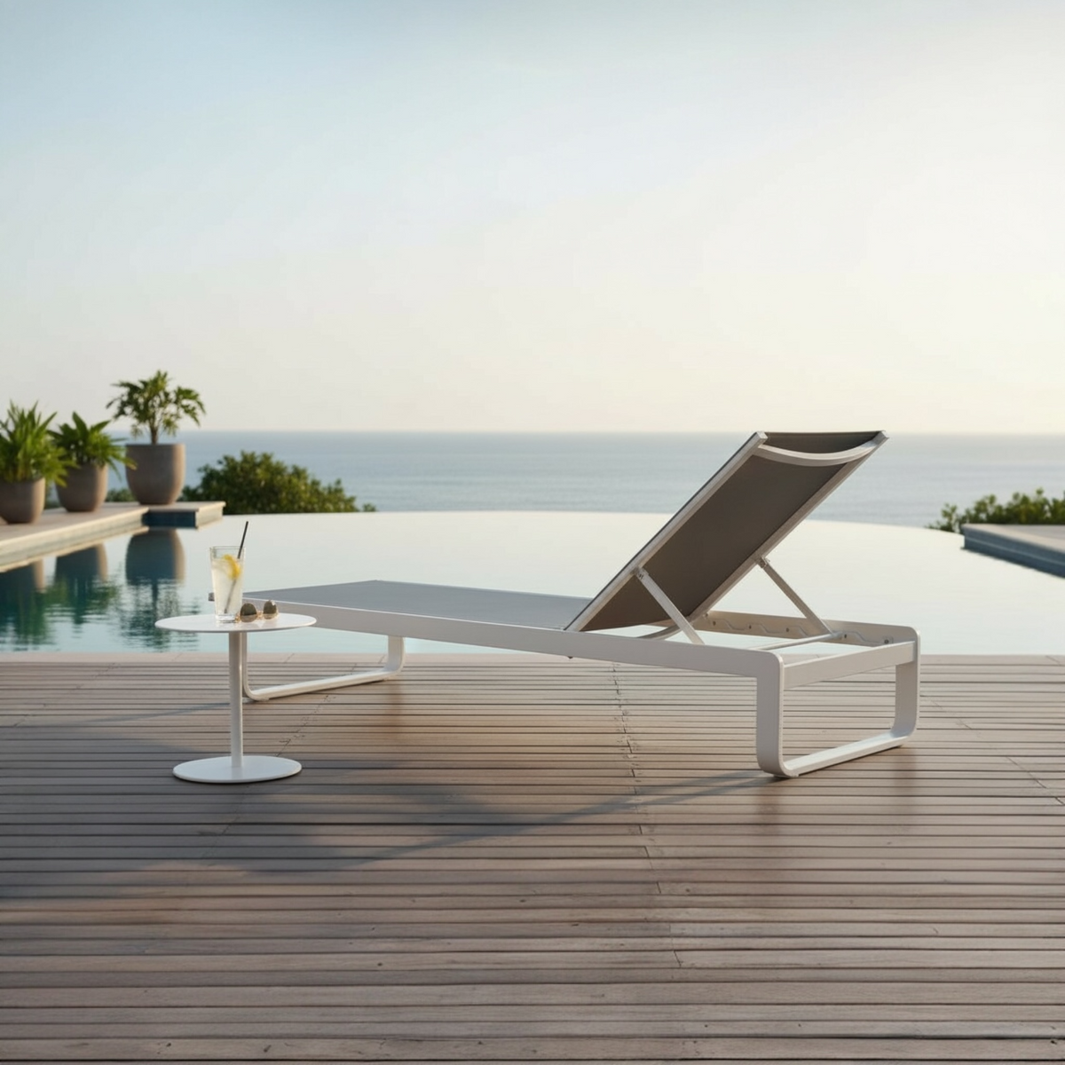 Romy white aluminum chaise lounge with gray textilene – shown outdoors