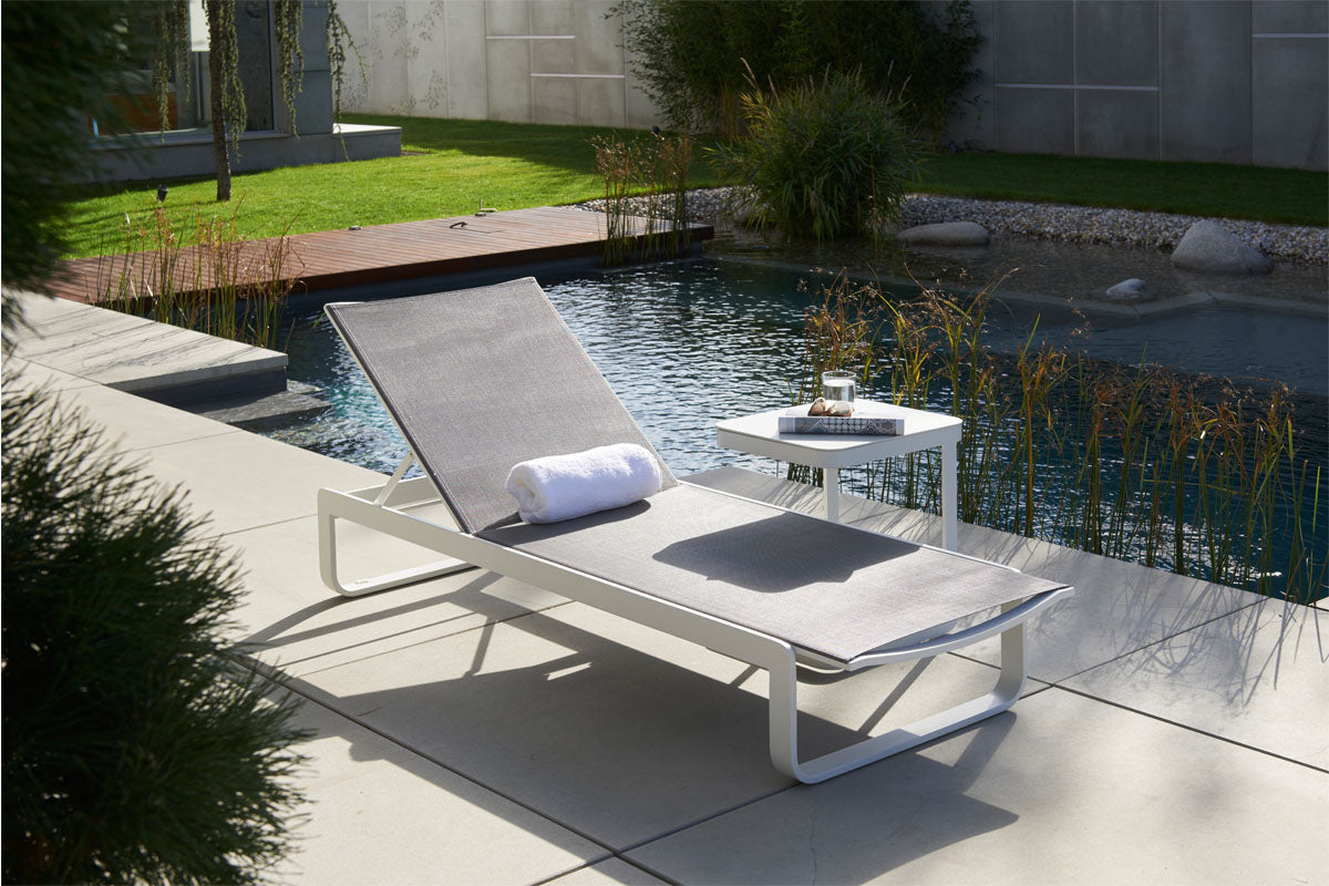 Romy white aluminum chaise lounge with gray textilene – shown outdoors (4)