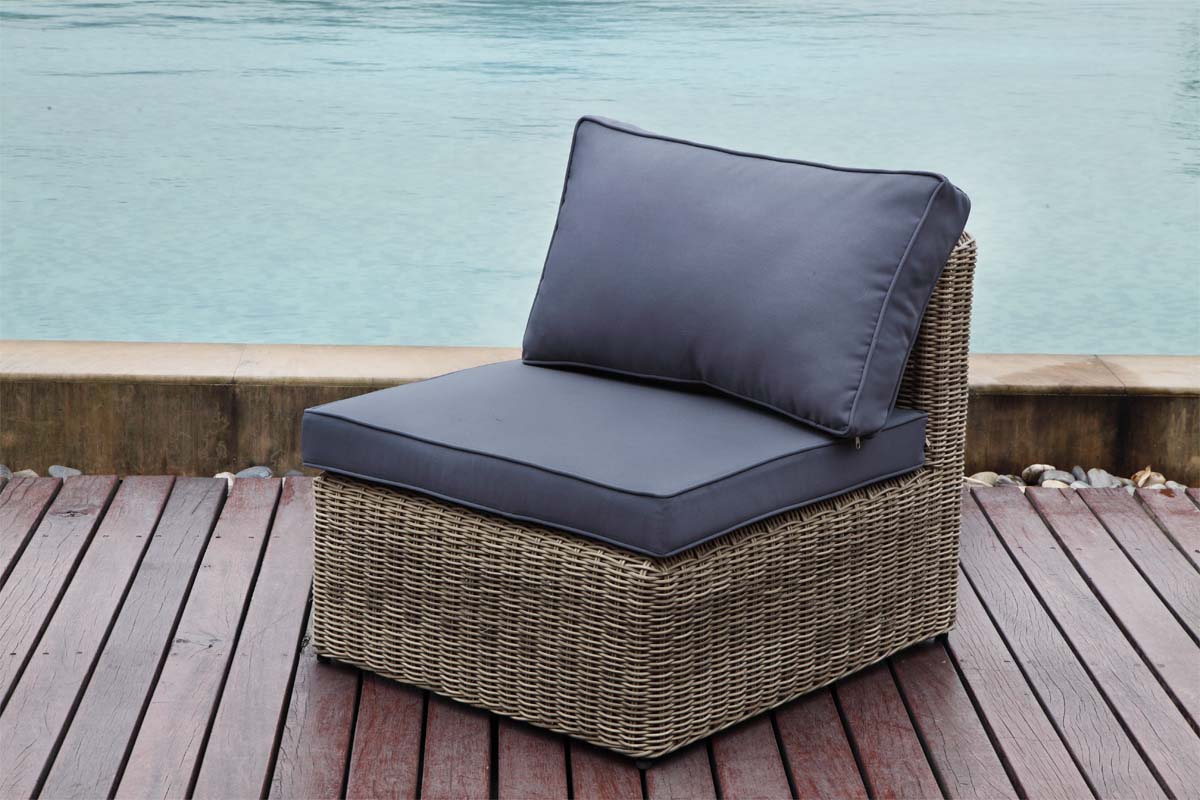 Armless chair from the Liberty Chic 7-seat modular resin wicker sectional with poufs – shown outdoors