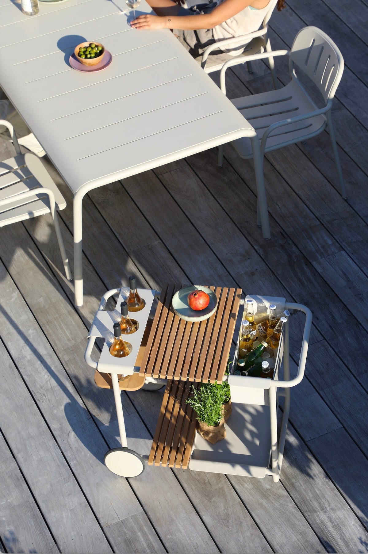 Sunny beige aluminum outdoor bar cart with cooler and teak trays – shown outdoors (3)