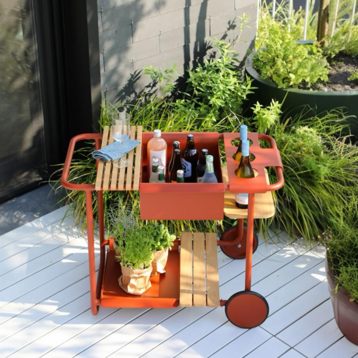 Sunny red aluminum outdoor bar cart with cooler – shown outdoors