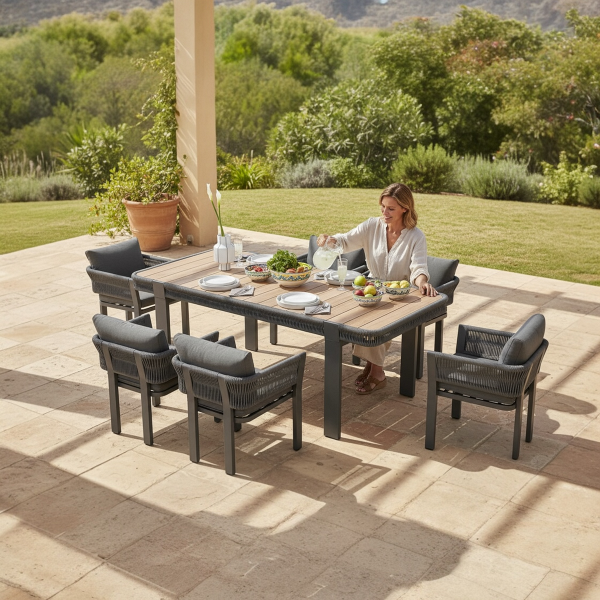 Olby black rope outdoor dining set with six armchairs and teak table – shown outdoors (3)