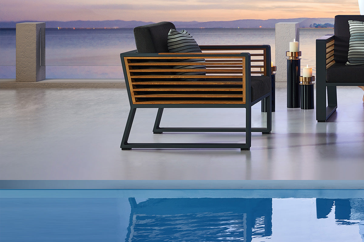Armchair from the Cofy aluminum and teak outdoor sectional with drink cooler coffee table – shown outdoors (2)