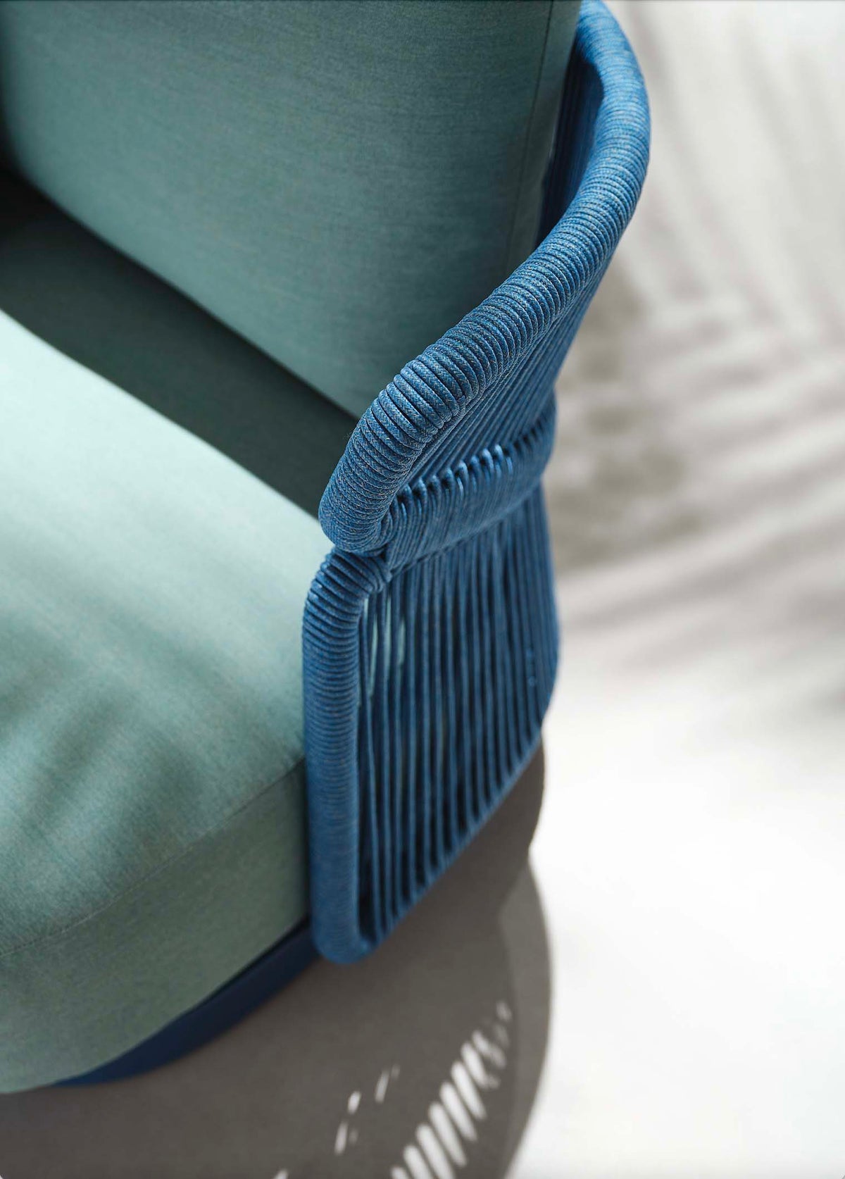 Armchair from the Laska blue aluminum and braided rope patio set with teak-top tables – close-up detail