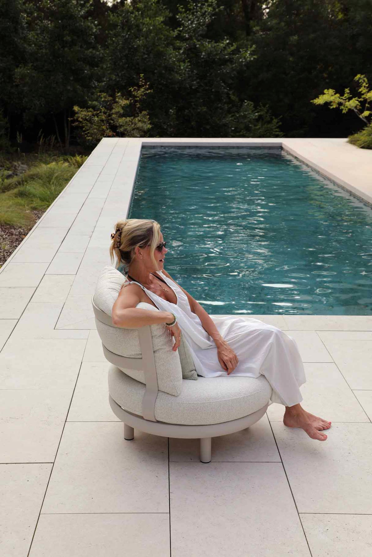 Armchair from the Rosa Mini compact aluminum and teak modular outdoor sofa set – shown outdoors