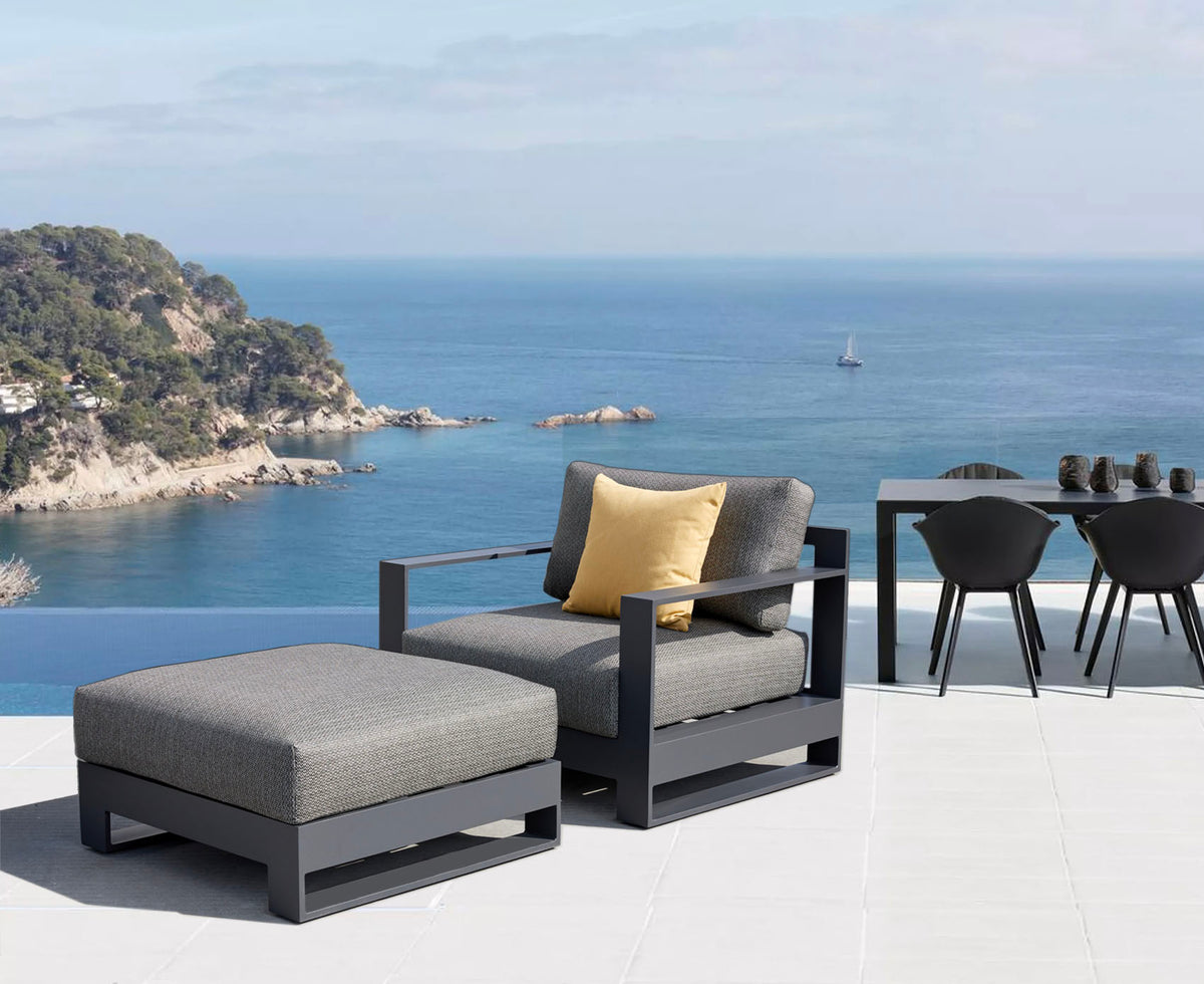 Iris black aluminum outdoor lounge chair with ottoman – shown outdoors (3)