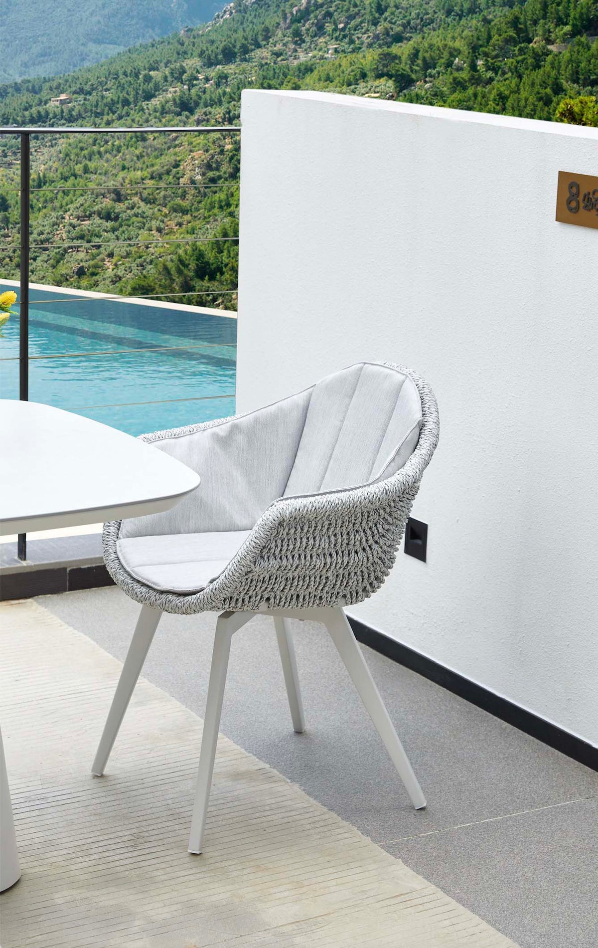Milo white resin wicker dining armchairs, set of 2 – shown outdoors (2)