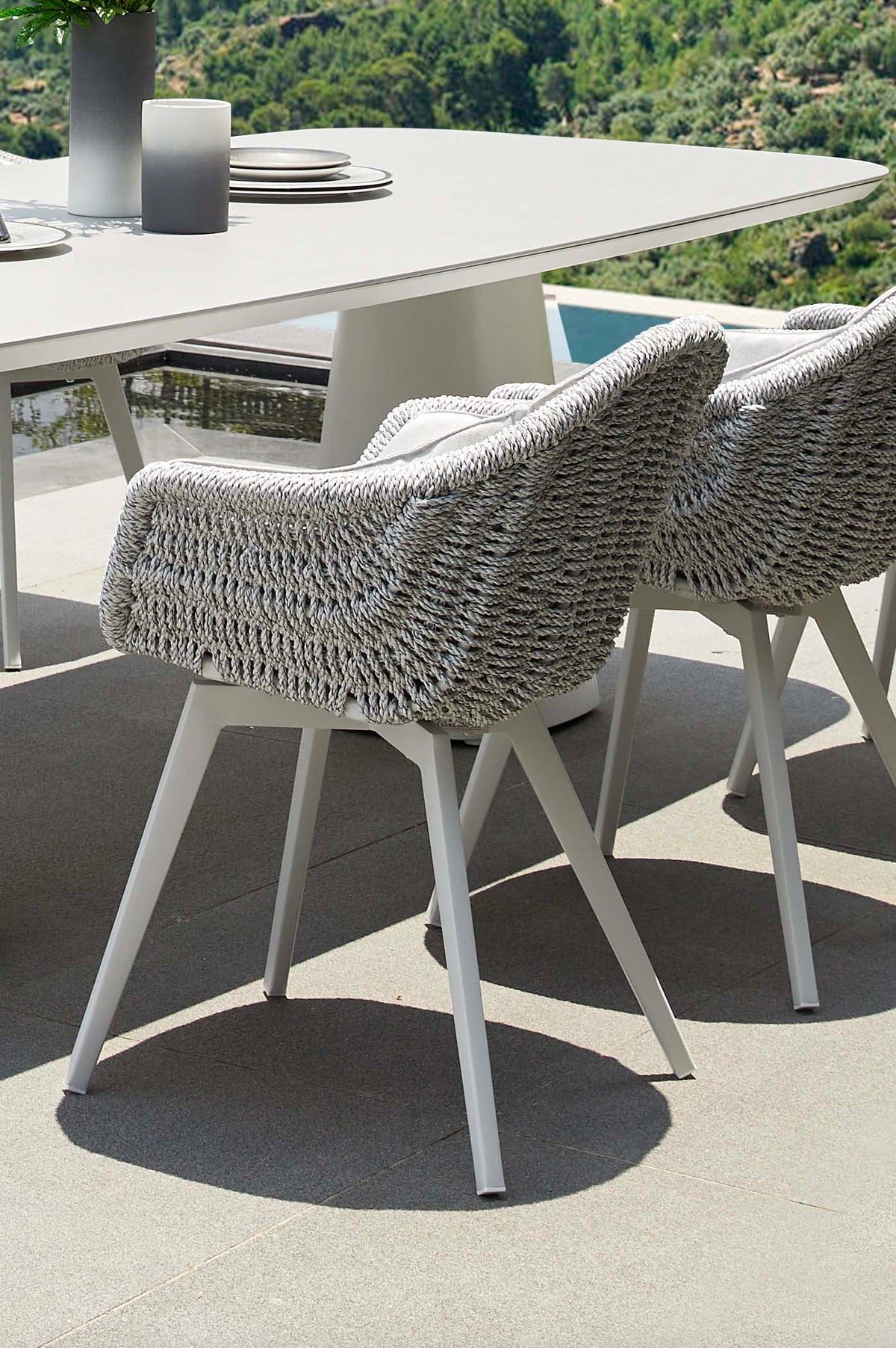 Milo white resin wicker dining armchairs, set of 2 – shown outdoors (3)