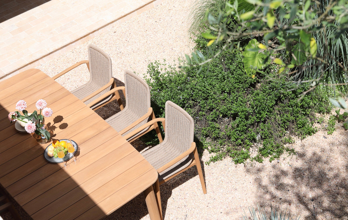 Paula solid teak and taupe rope dining armchair – shown outdoors (4)