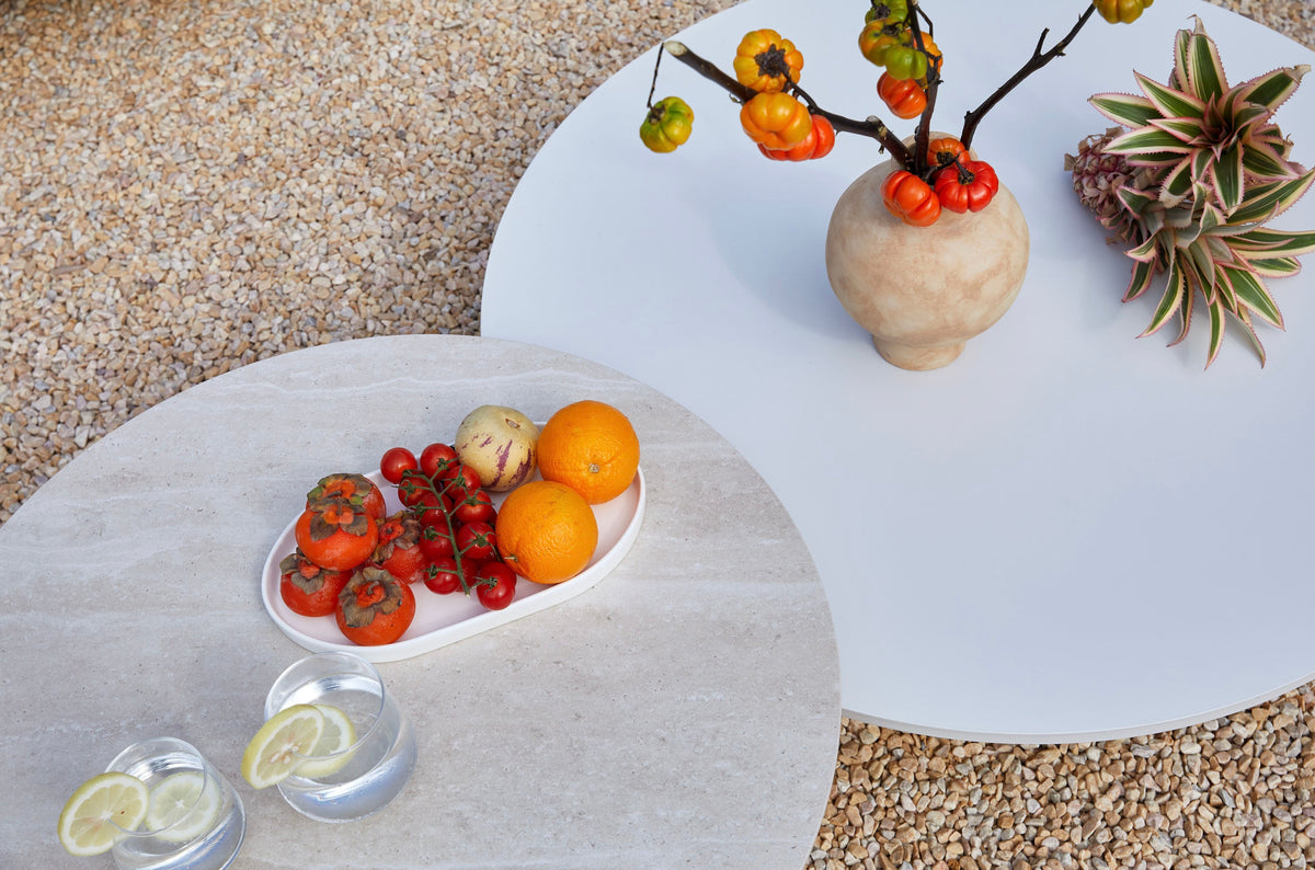 Coffee table from the Flora white aluminum outdoor sectional with light gray cushions – close-up detail