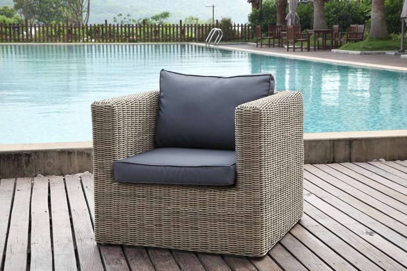Armchair from the Liberty Club 2-seat resin wicker patio set with glass-top table – shown outdoors