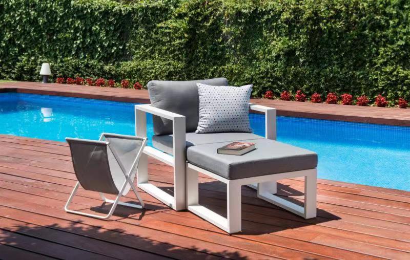 Belly white aluminum outdoor armchair with matching ottoman – shown outdoors (4)