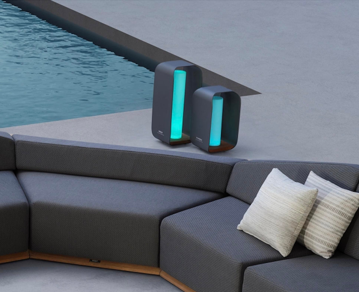 Onda gray aluminum and teak cordless outdoor lamp – shown lit outdoors