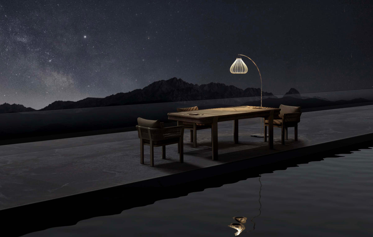 Apollo beige arched solar outdoor floor lamp – shown lit outdoors