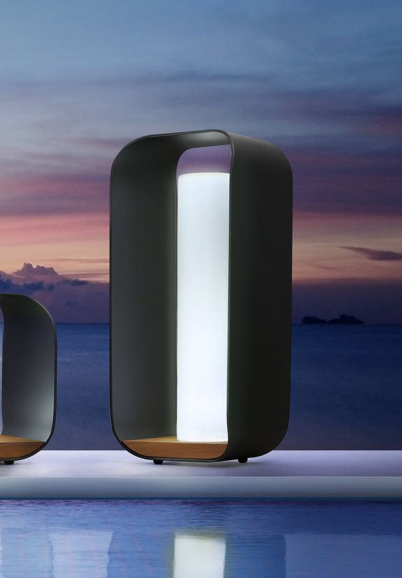 Onda black aluminum and teak cordless outdoor lamp – shown lit outdoors