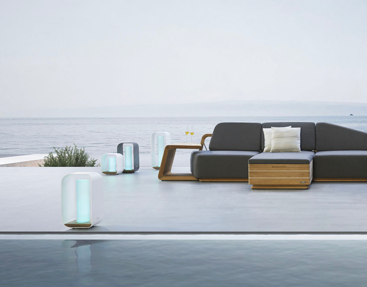 Onda white aluminum and teak cordless outdoor lamp – shown outdoors