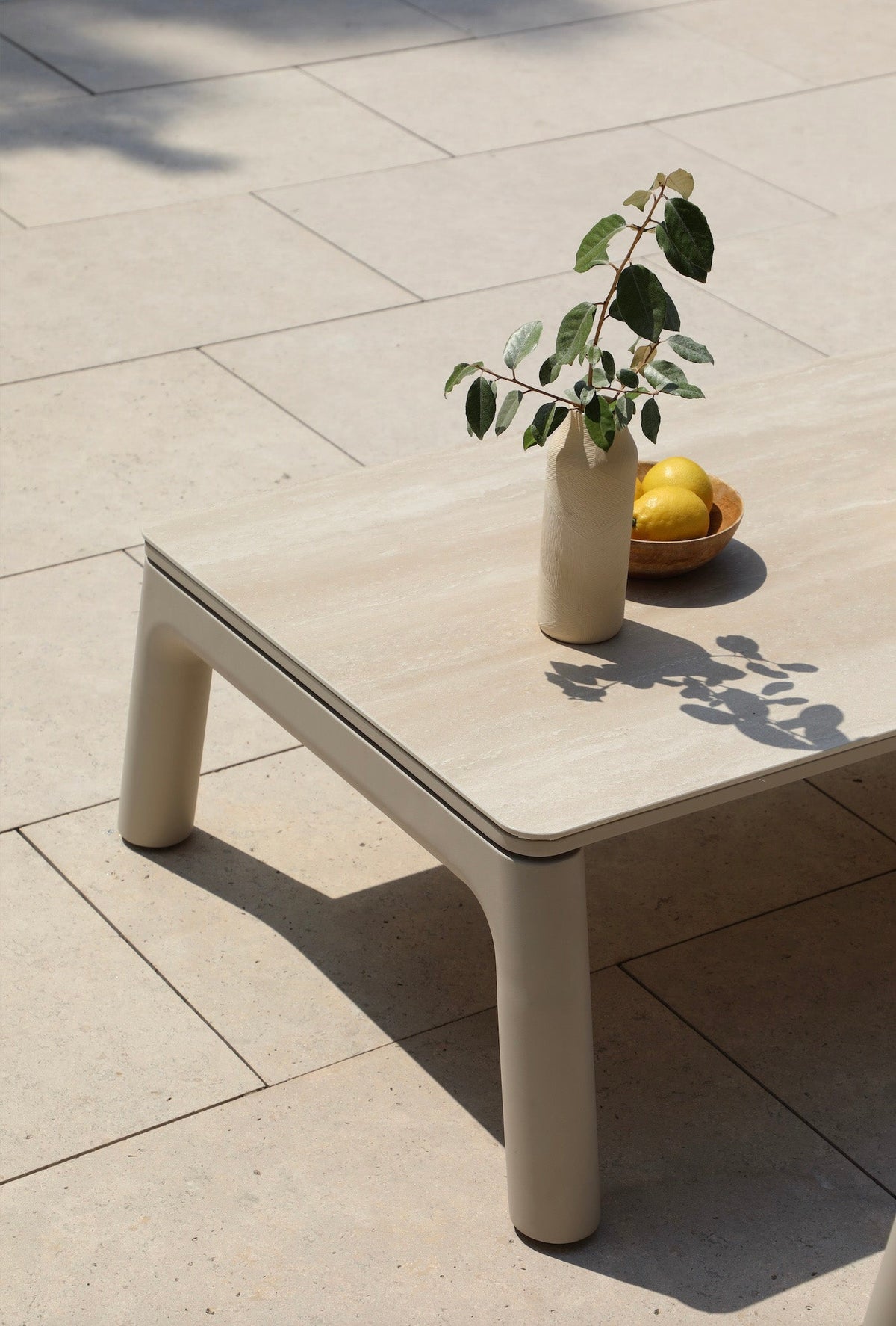 Coffee table from the Matia convertible aluminum and rope outdoor sofa set in neutral tones – shown outdoors (2)