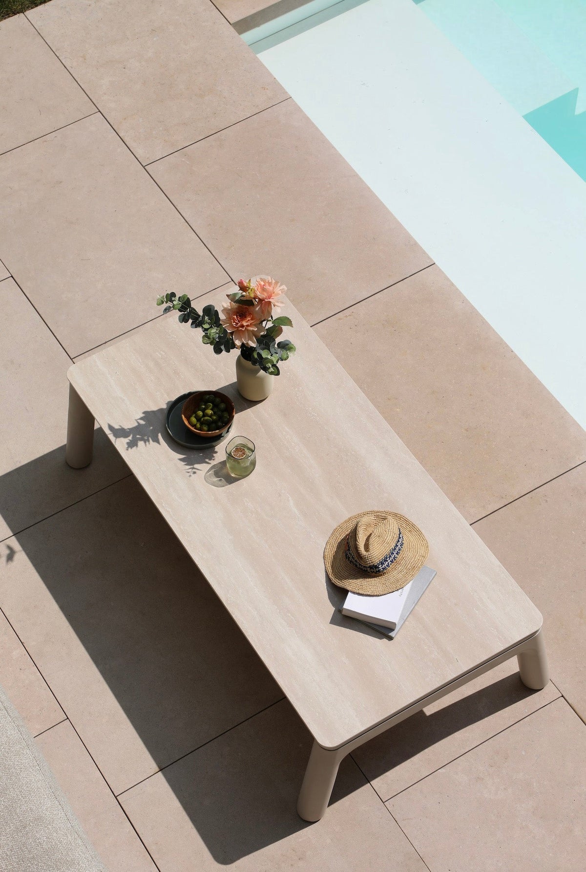 Coffee table from the Matia convertible aluminum and rope outdoor sofa set in neutral tones – shown outdoors