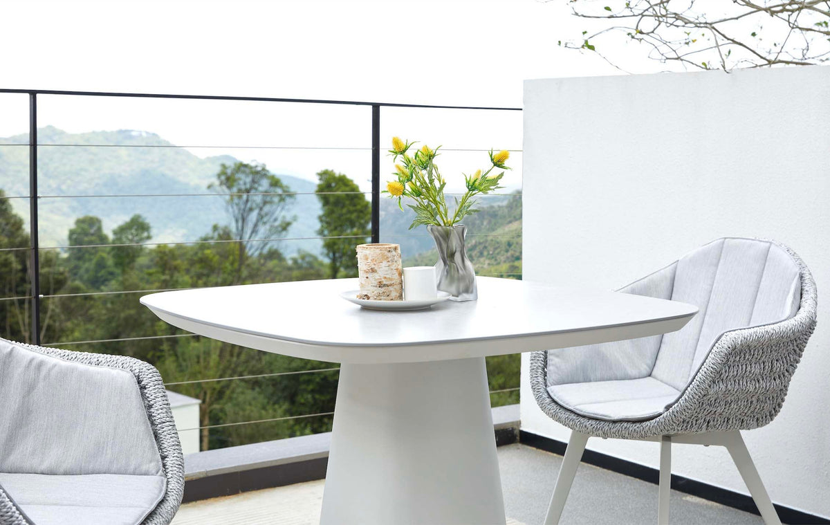 Milo square gray ceramic aluminum outdoor dining table – shown outdoors (4)