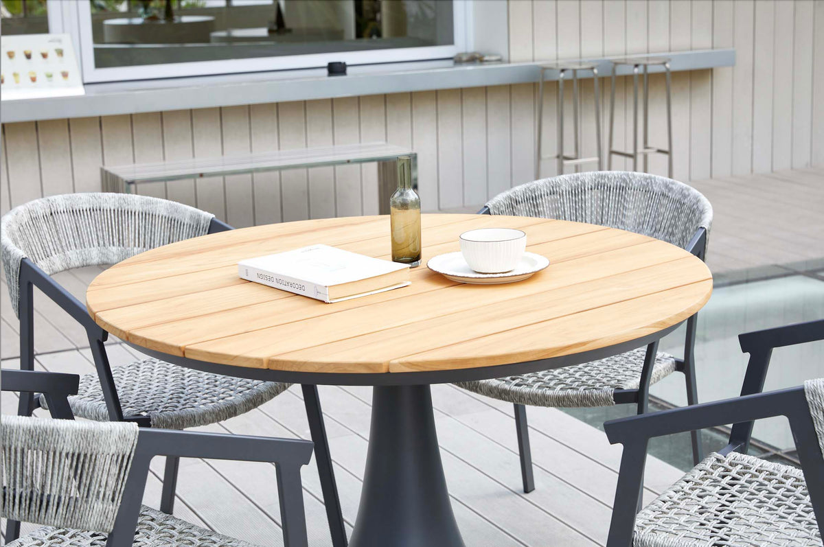 Fano black aluminum round teak-top patio table – shown outdoors (6)