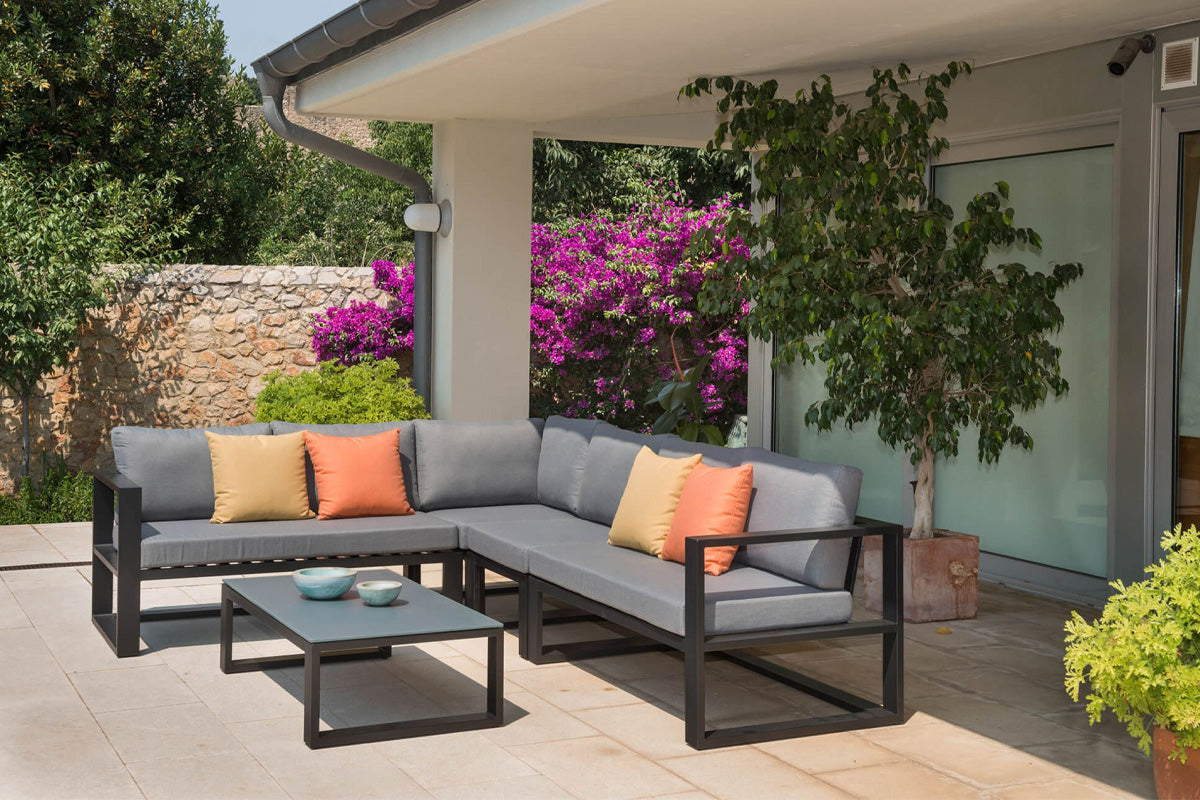 Belly Cosy small black aluminum outdoor sectional with glass coffee table – shown outdoors (3)